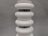 a close up of a white light bulb on a table