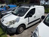 a white van parked in a parking lot with other cars