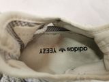 the shoe is white and has a black stripe on the side of it