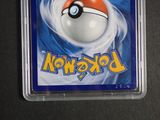 a pokemon trading card in a plastic holder on a table