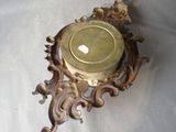 a gold clock on a white table with a white table cloth