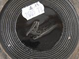 a picture of a black plate with a name tag on it