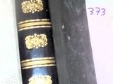 a book that is sitting on a table next to a pen