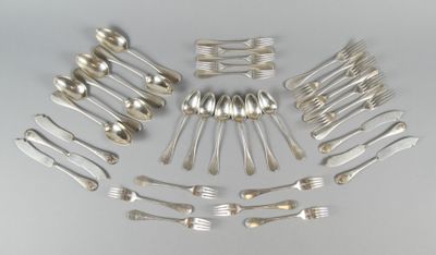 a lot of silver spoons and forks arranged in a circle