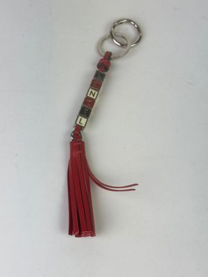 a keychain with a red tassel hanging from it