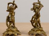 pair of antique bronze figurines of a boy and a girl