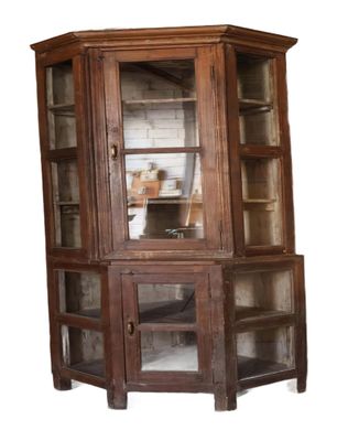 une armoire d'angle avec une porte vitrée et des étagères