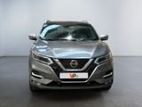 the front of a silver nissan qx parked in a showroom