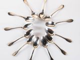 a lot of spoons arranged in a circle on the table