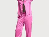 woman in pink pajamas posing with her arms behind her head