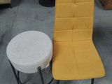 a yellow chair and a white stool in a warehouse