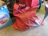 a red bag and a blue bag sitting on the floor