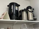 a shelf with pots and pans on it in a kitchen