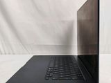 an open laptop computer sitting on top of a white surface