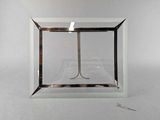 a glass box with a pair of scissors inside of it