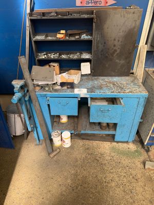 a blue workbench with tools on it in a garage