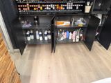 a black cabinet with a lot of bottles and bottles on it