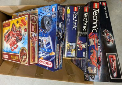 a lot of legos in a box on the floor