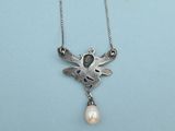 a close up of a necklace with a bird and a pearl