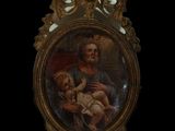 painting of a man holding a baby in a gold frame