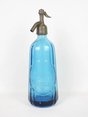a blue glass bottle with a brass handle on a white background