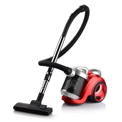 the red vacuum is sitting on the floor next to the black handle