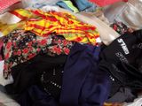 a suitcase full of clothes on a bed in a room