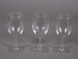 three empty wine glasses sitting on a table