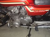 a red motorcycle that is parked in a garage