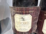 three bottles of wine sitting on a table next to each other