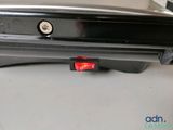 a close up of a black suitcase with a red button