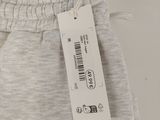 the back of a pair of grey sweat pants with a tag on it