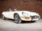 an image of a white sports car parked in front of a brick wall