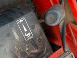 a close up of a red tractor with a sign on it