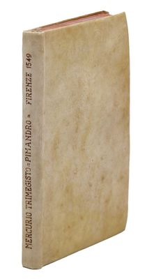 an old book sitting on top of a white table next to a white wall