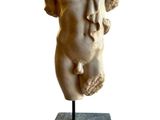 marble statue of a female torso on a marble base
