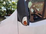 a man that is taking a picture of himself in the mirror of a truck