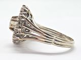 an image of a silver ring with a flower on top of it