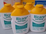 six bottles of bioare and a tube of toothpaste sit on a table