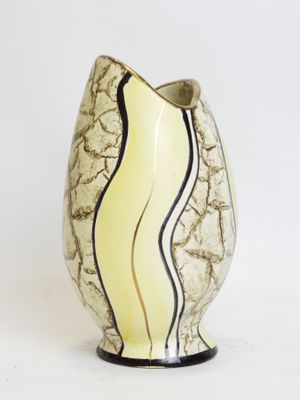 a white vase with a black and yellow stripe on it
