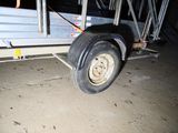 a trailer with a trailer attached to it in a garage