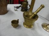 a gold mortar and a brass cup on a table