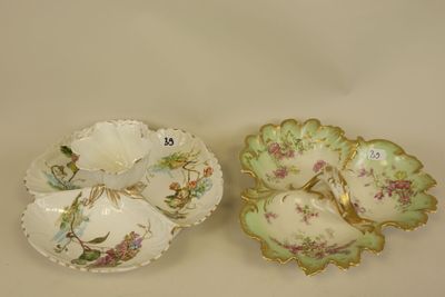 two porcelain dishes with floral designs on them sitting on a table