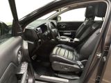 the interior of a car with the door open and the driver ' s seat down