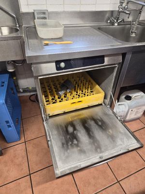 an image of a dirty kitchen with a dishwasher in it