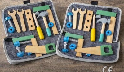 two suitcases with different tools in them on a table
