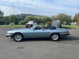 an image of a blue convertible car parked in a parking lot
