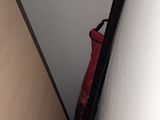 a red bag sitting on top of a wooden door