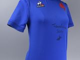 a women ' s blue rugby shirt with a red rose on the chest