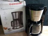 a coffee maker sitting next to a box on a table
